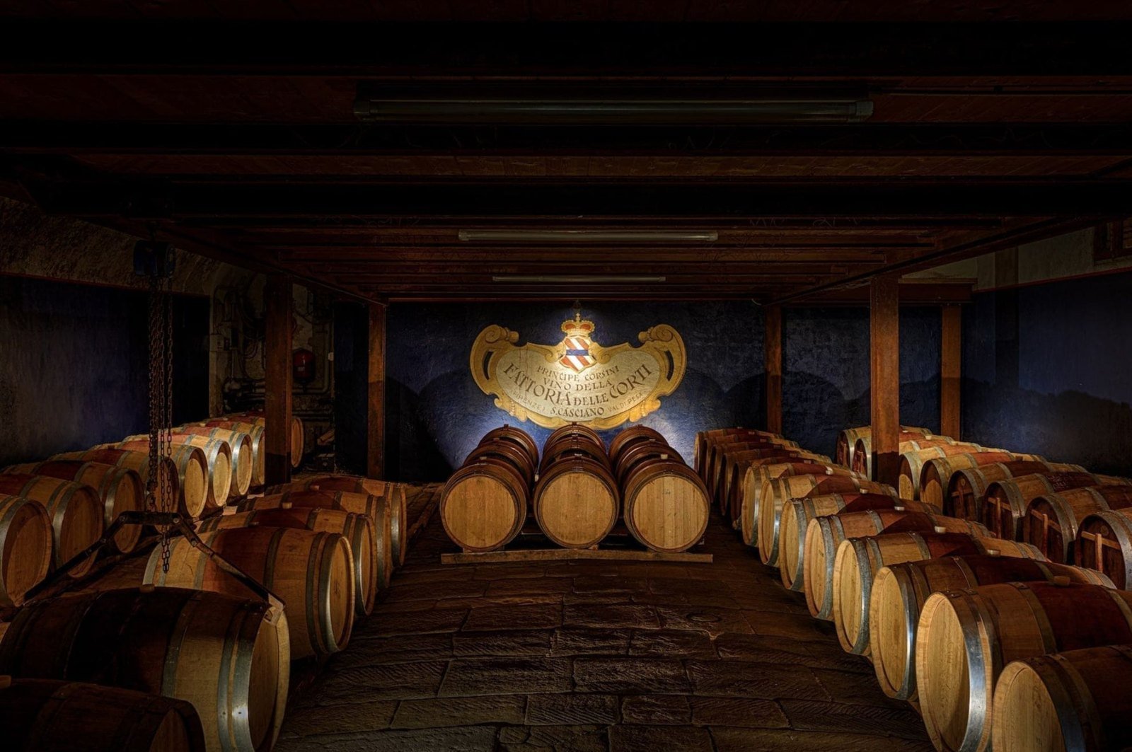 Visual reference from the Corsini treatment: wine barrels inside a historic cellar